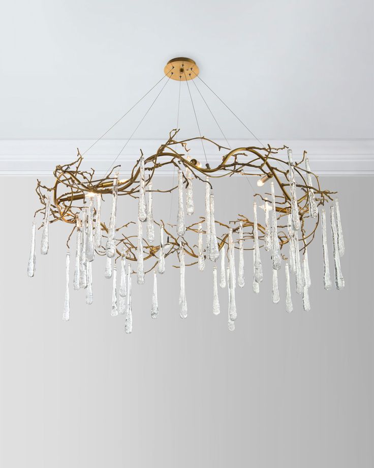 a chandelier hanging from the ceiling in a room with white walls and flooring