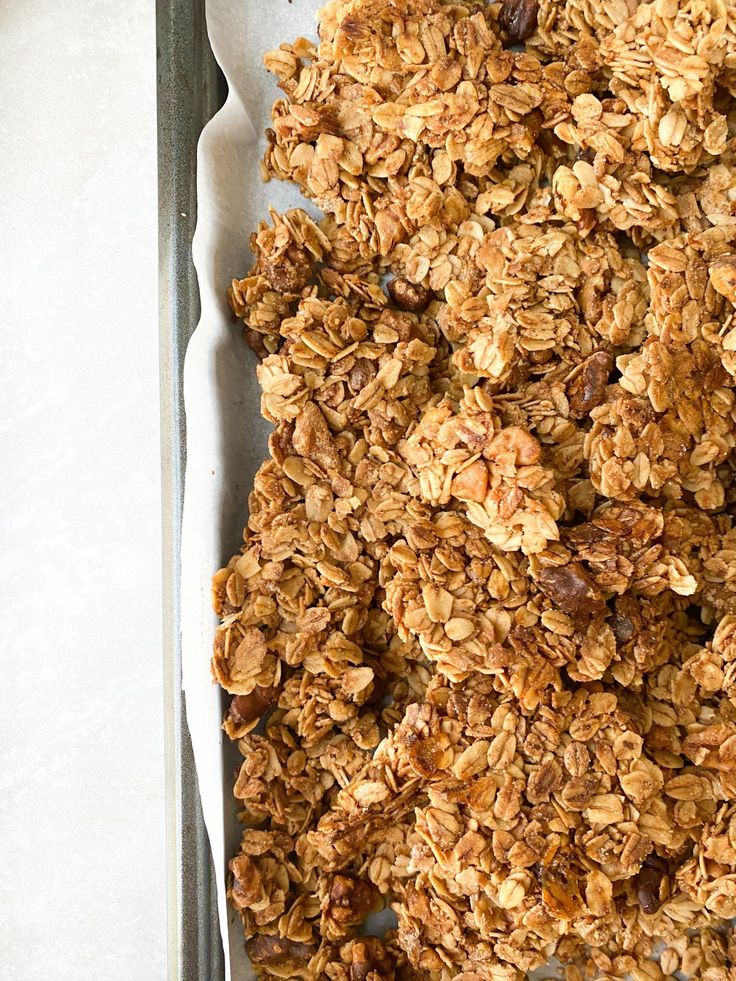 an image of granola on a baking sheet