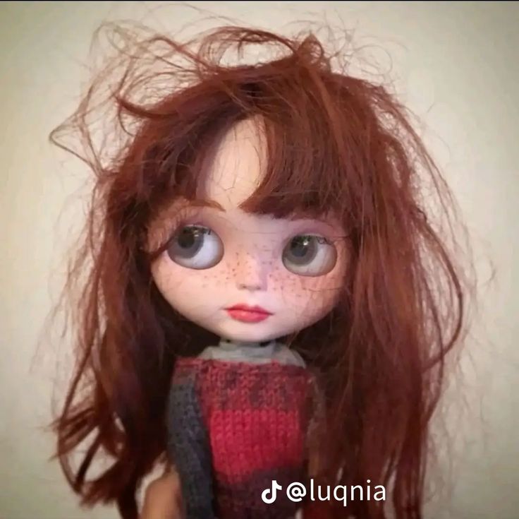 a close up of a doll with long hair