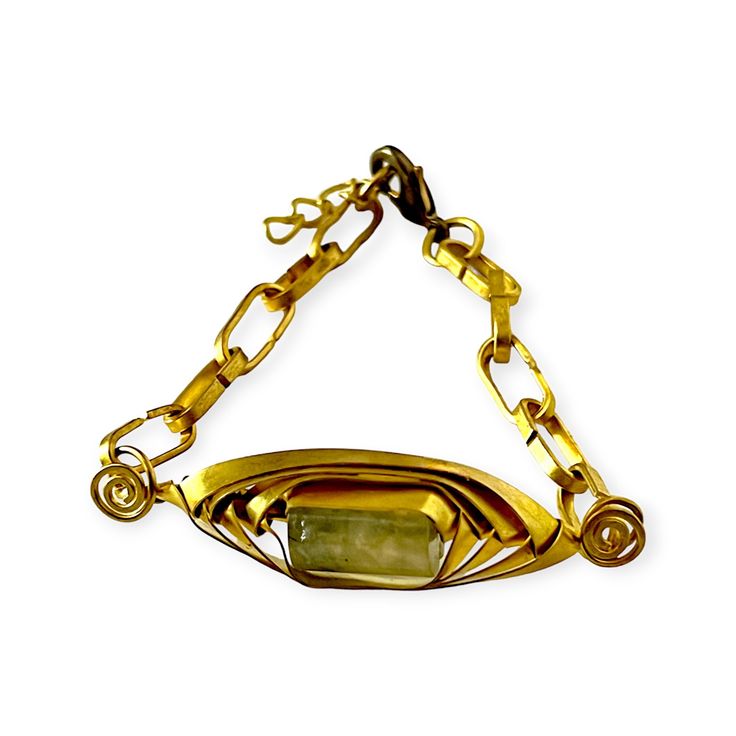 Introducing our art deco inspired chainlink bracelet. Handwoven with modern and tribal elements, it features a stunning prehnite stone for a touch of elegance. The paperclip chain and lobster clasp complete its versatile design. Elevate any outfit with this unique and stylish handmade bracelet. Given the artist only made three, this special bracelet is a piece for the individualist, someone who relishes unique jewelry. Its a wonderful piece to mix and match with your favorite bracelets to create Modern Handmade Jewelry With Rectangular Links, Elegant Handmade Brass Chain Bracelet, Elegant Adjustable Geometric Bracelet, Modern Handmade Oblong Jewelry, Elegant Geometric Bracelets Gift, Elegant Geometric Bracelets For Gifts, Elegant Geometric Bracelets For Gift, Art Deco Metal Bracelets For Gifts, Art Deco Metal Bracelets For Gift