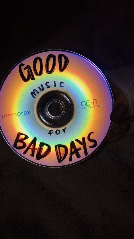 a cd with the words good music for bad days written on it in rainbow colors