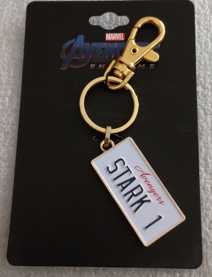 a keychain with the name stark on it and a tag attached to it