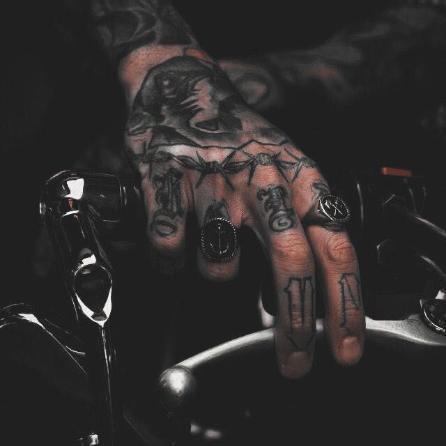 a person with tattoos on their hands and fingers