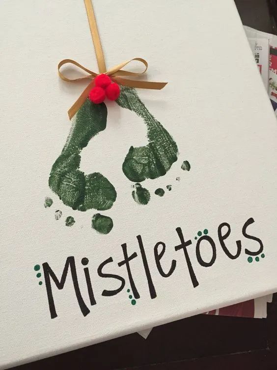 a handprinted christmas card with the word mistle toes on it and a red bow