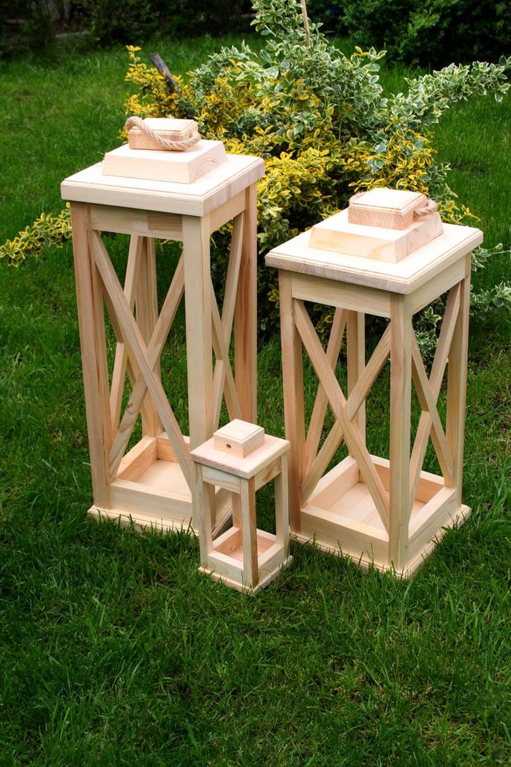 two wooden planters sitting in the grass