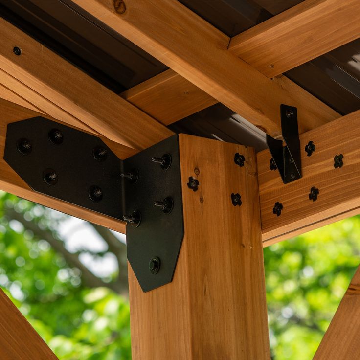 a wooden structure with metal brackets attached to it