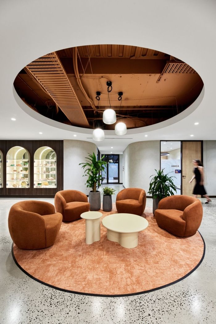 an office lobby with modern furniture and large circular carpeted flooring in the center