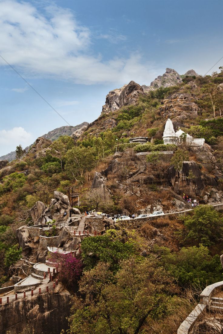 the top of a mountain with many steps leading up to it and some buildings on each side