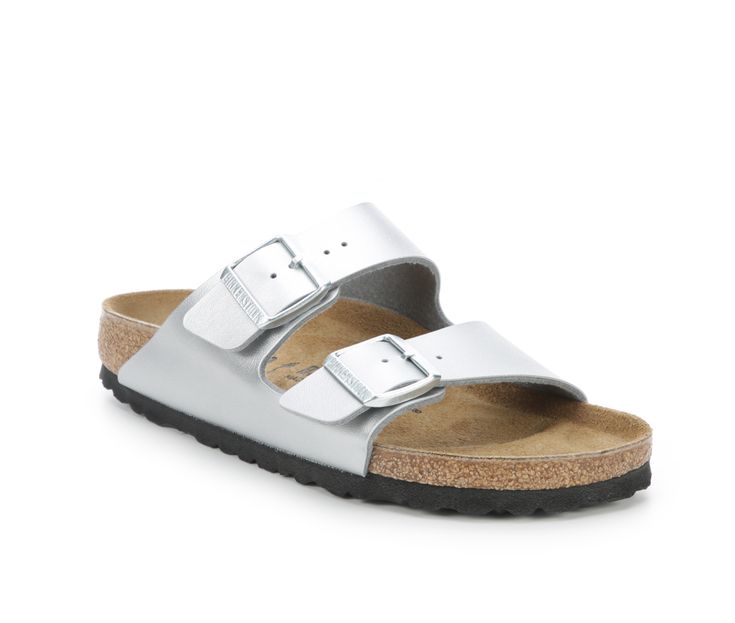 Women's Birkenstock Two-Strap Cork Sandals. From the brand that is known for creating and perfecting a tradition of walking comfort, we present the Birkenstock Arizona! These slip-on sandals feature dual adjustable straps at the vamp for a secure fit. The original Birkenstock footbed offers arch support, a deep heel cup, and a roomy toe box so you and your feet can kick back and enjoy the day! Please note - The style fits like a US medium width but listed by Birkenstock as Narrow Fit on the item Silver Slides With Leather Footbed, Casual Silver Sandals With Leather Footbed, Enjoy The Day, Cork Sandals, Birkenstock Women, Footbed Sandals, Kick Backs, Birkenstock Arizona, The Vamps