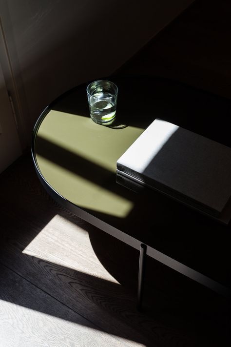 a table with a book and a glass on it in the sun shining from behind