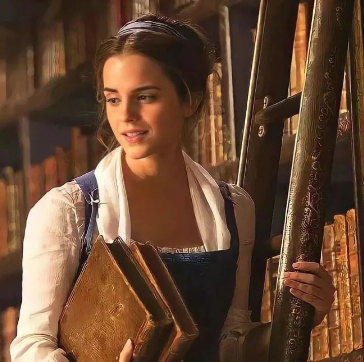 a beautiful young lady holding a book in front of bookshelves