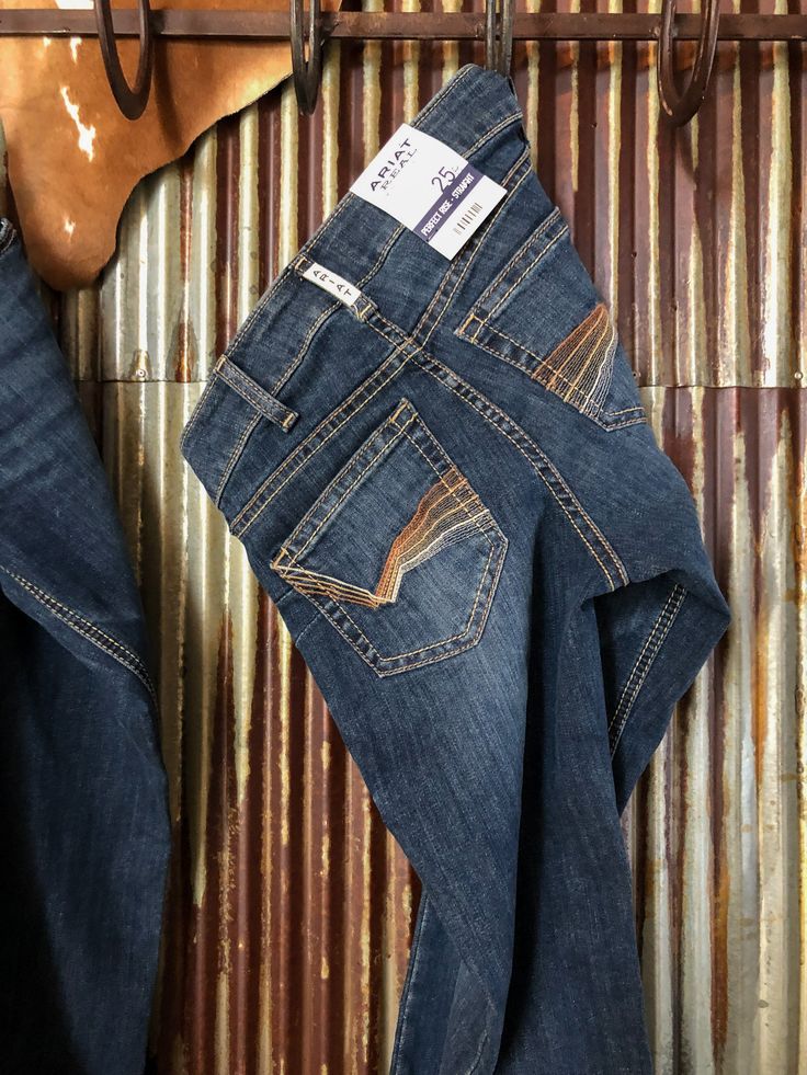 Our newest medium wash denim straight leg jean from Ariat. Two tone natural stitching on pockets. Back pockets also have a 4 tone stitching design. Light hand sanding and whisker wash. Nice soft lighter weight stretch. Comfy no-gap waist. Copper logo hardware. Perfect rise, sits between a mid and high rise to compliment your natural waist. 9" Perfect Rise, based on a size 28. Rise will be slightly lower for smaller sizes and slightly higher for larger sizes. Slightly higher in back for the perfe Copper Logo, Ariat Jeans, Dream Style, Design Light, Country Outfits, Miss Me Jeans, Fit Check, Western Outfits, Rock Revival Jean