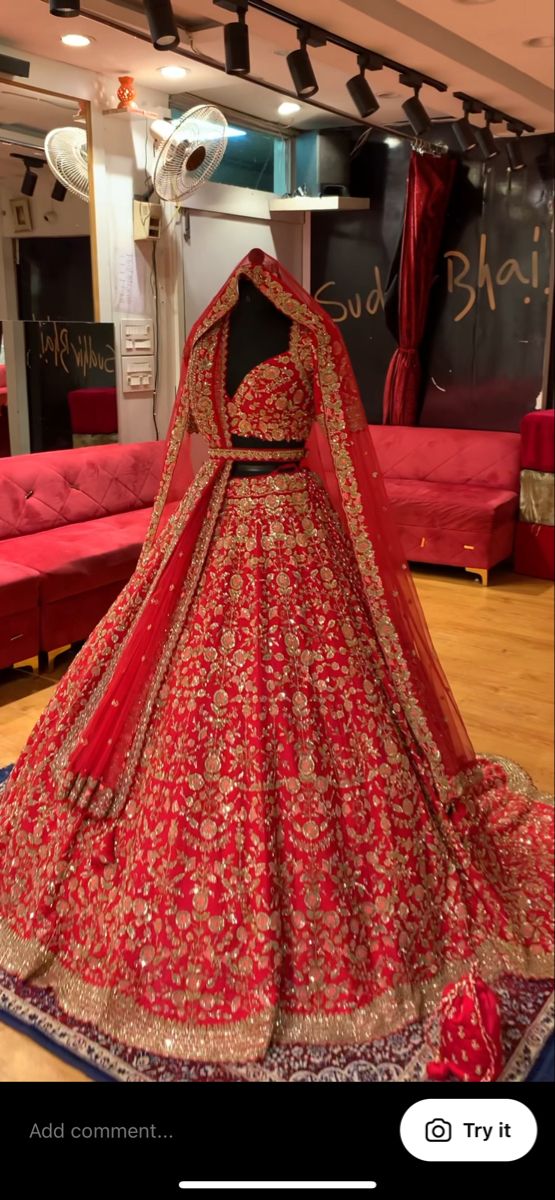 a red bridal gown on display in a store