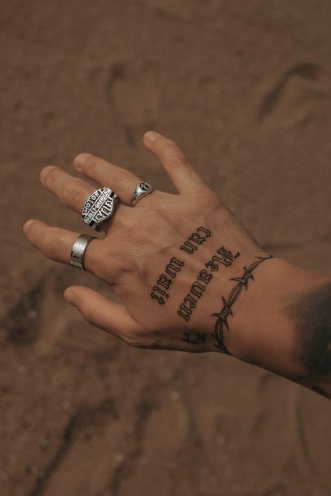 a person's hand with tattoos on it