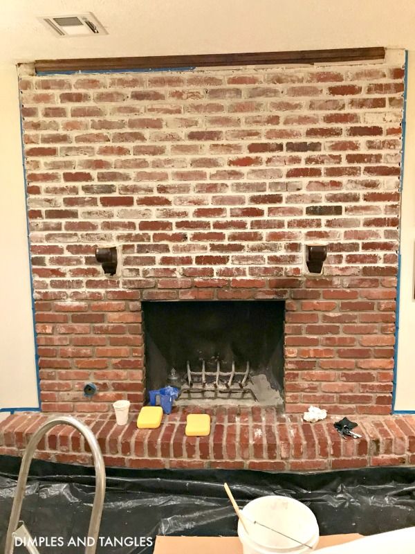 a brick fireplace being installed in a living room