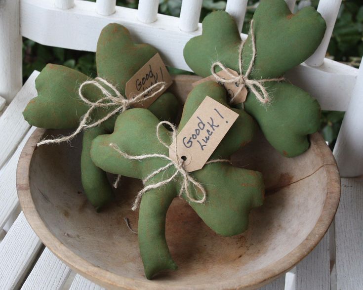 three green teddy bears sitting in a bowl on a white chair with a sign that says good luck