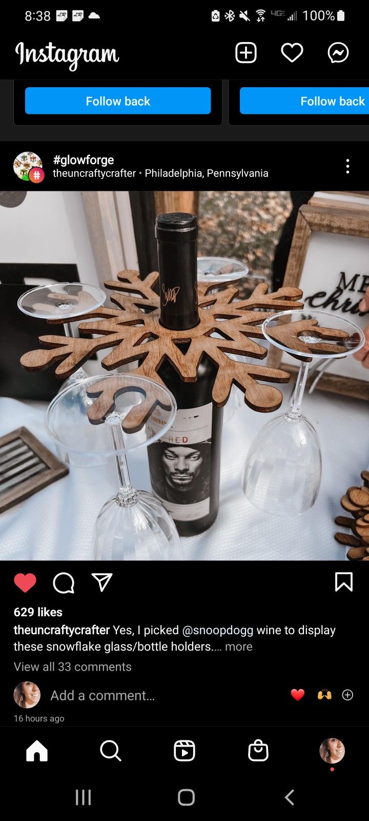 a bottle of wine sitting on top of a table next to a glass filled with cookies