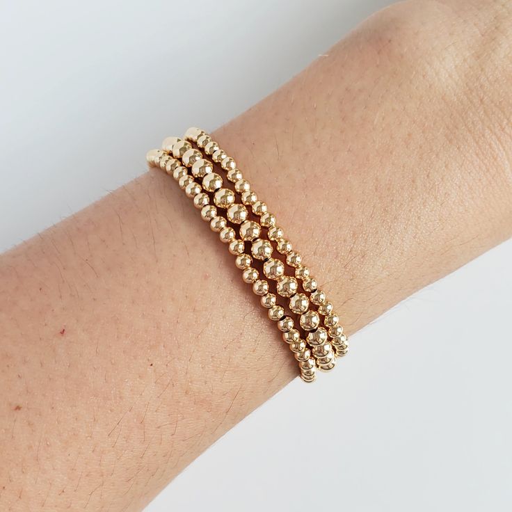 A classic gold bead bracelet is a perfect addition to a dainty stack. The beads are strung on a premium stretch cord.SOLD BY SET OF 3 BRACELETSDETAILS:- 18K gold plated brass beads made to last- round bead size: 1x4mm, 1x3mm, 1xRainbow Pearl Gold Beads Bracelet, Gold Beaded Bracelets, Bracelets Dainty, Metal Core, Gold Bracelet Set, Gold Bond, Brass Beads, Gold Bead Bracelets, Classic Gold