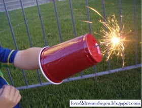 a person holding a red cup with sparklers in it's hand and the caption reads, you can improve your own with a large, round sticker,