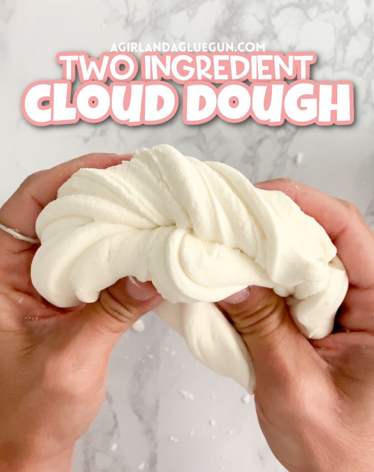 two hands holding a white doughnut with the words, two ingredient cloud dough