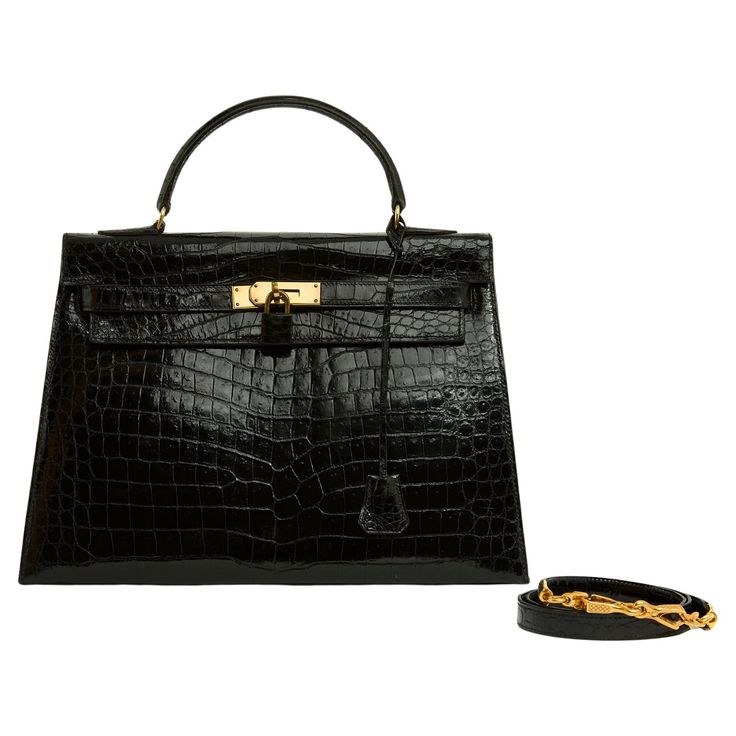 Hermès bag, Kelly saddle model, size 32, in black Porosus crocodile and gold metal, circa 1965, interior in black leather with a patch pocket on one side and a double patch pocket on the other, zipper, bell, keys, padlock covered with coordinated leather, coordinated shoulder strap but not original and not signed Hermès. Width 32 cm x height 22 cm x depth 11 cm, handle 30 cm, shoulder strap 90 cm. The bag is in excellent condition, hardware has only been cleaned with a cloth, and the leather in Birkin Sellier, Kelly 32, Snake Skin Bag, Jane Birkin, Hermes Bag, Handle Bag, Hermes Birkin, Bag Straps, Fashion Handbags