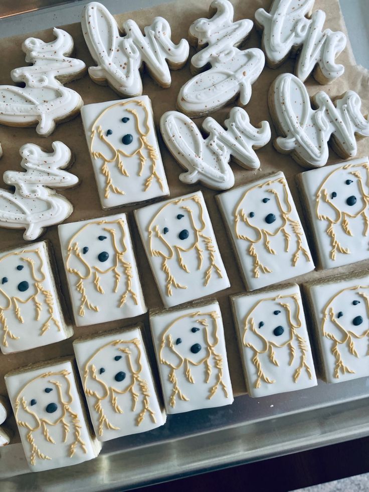 some cookies that have been decorated to look like people's faces and letters on them