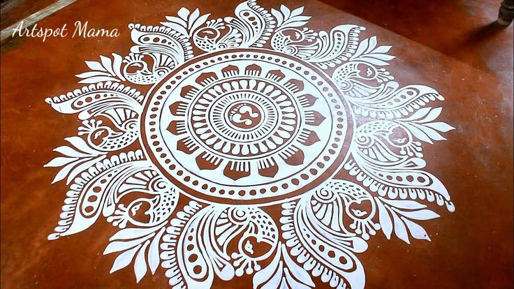 an intricately designed wooden table top with white paint on the surface and brown wood flooring