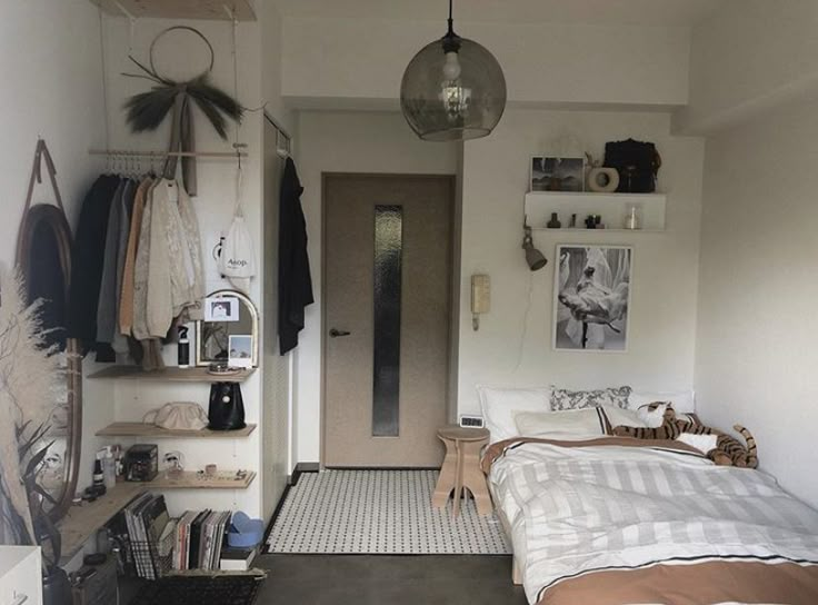 a bed room with a neatly made bed next to a door and shelves on the wall