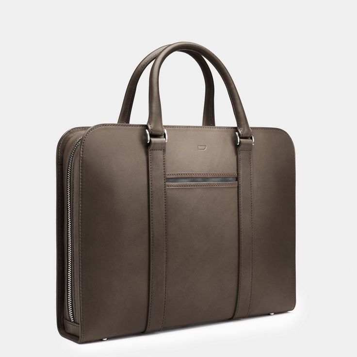 A contemporary case acting as personal portfolio; an everyday companion for the modern gentleman. Modern Briefcase With Top Carry Handle, Modern Rectangular Briefcase For Business Trips, Modern Travel Briefcase Rectangular Case, Modern Rectangular Laptop Bag For Business Trips, Modern Rectangular Briefcase With Luggage Sleeve, Modern Rectangular Laptop Bag For Travel, Modern Satchel For Business Trips, Modern Travel Laptop Bag Rectangular Case, Modern Brown Satchel For Formal Occasions