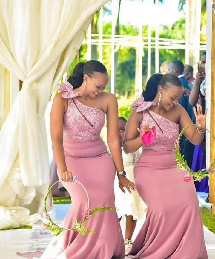 two women in pink dresses standing next to each other