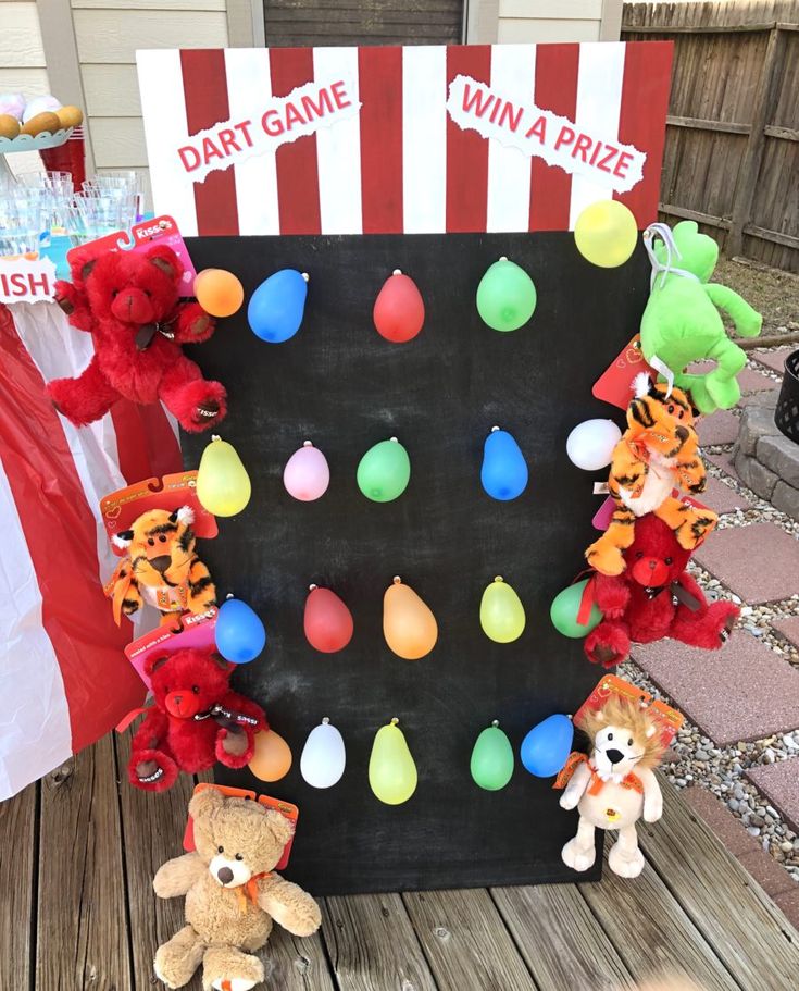 some stuffed animals are sitting in front of a board with game winning pieces on it