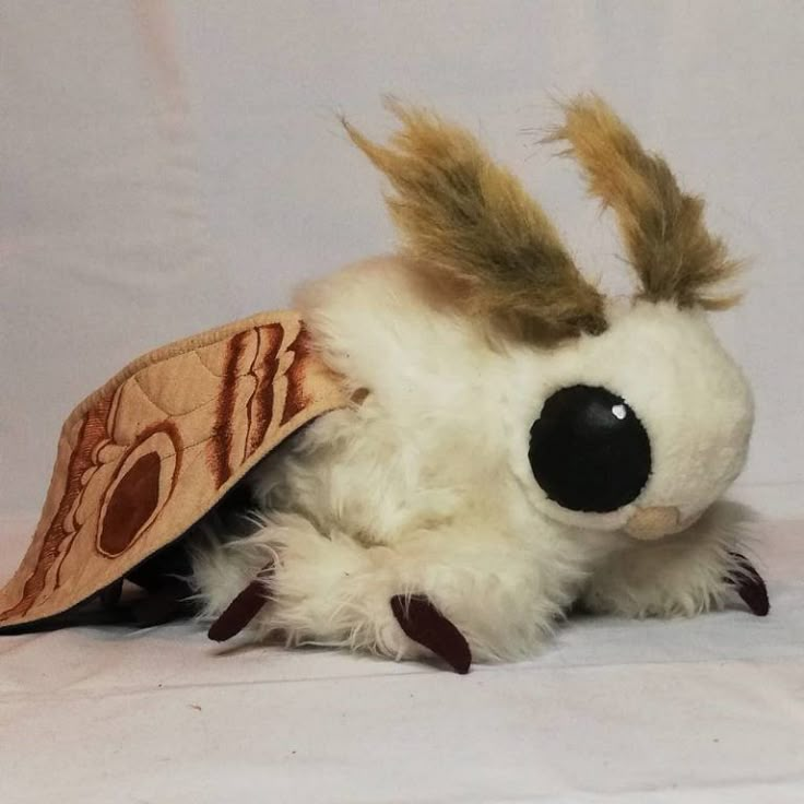 a stuffed animal with a hat on it's head and hair in the shape of a dog