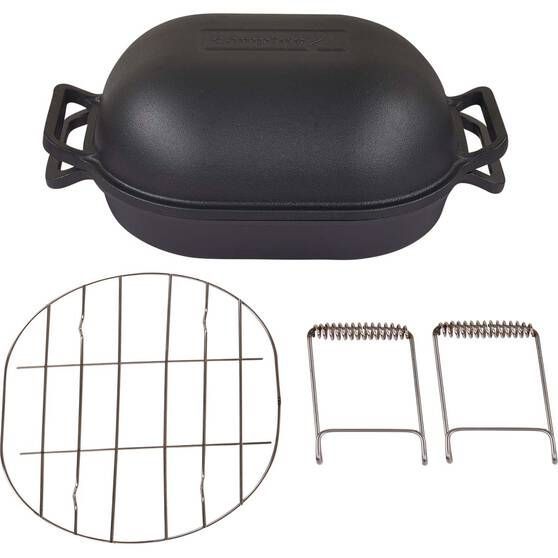 an image of a grill with tongs and grates on the side for cooking