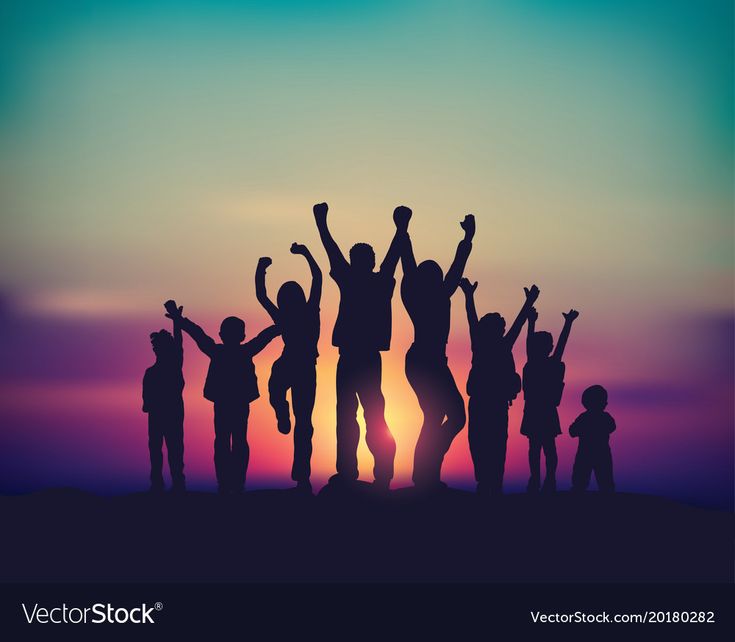 a group of people standing on top of a hill with their arms in the air