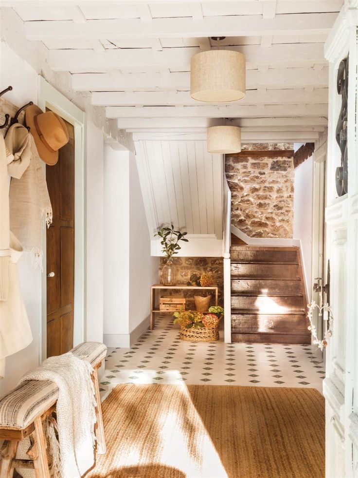 a hallway with white walls and wooden steps