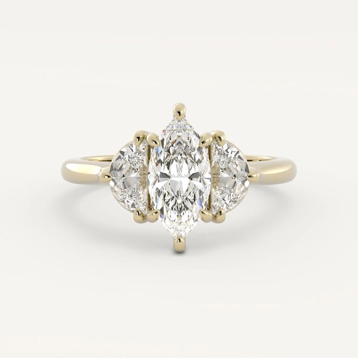 an oval cut diamond ring with three pear shaped diamonds on the sides and four clawed shoulders