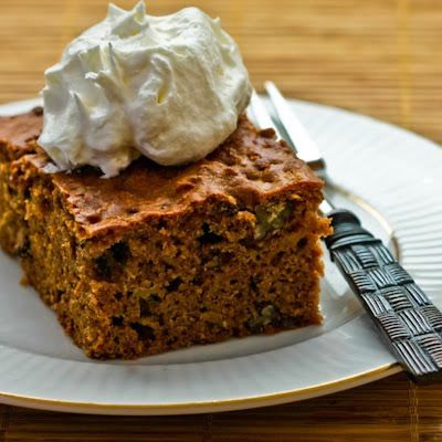 a piece of cake with whipped cream on top is sitting on a plate next to a fork