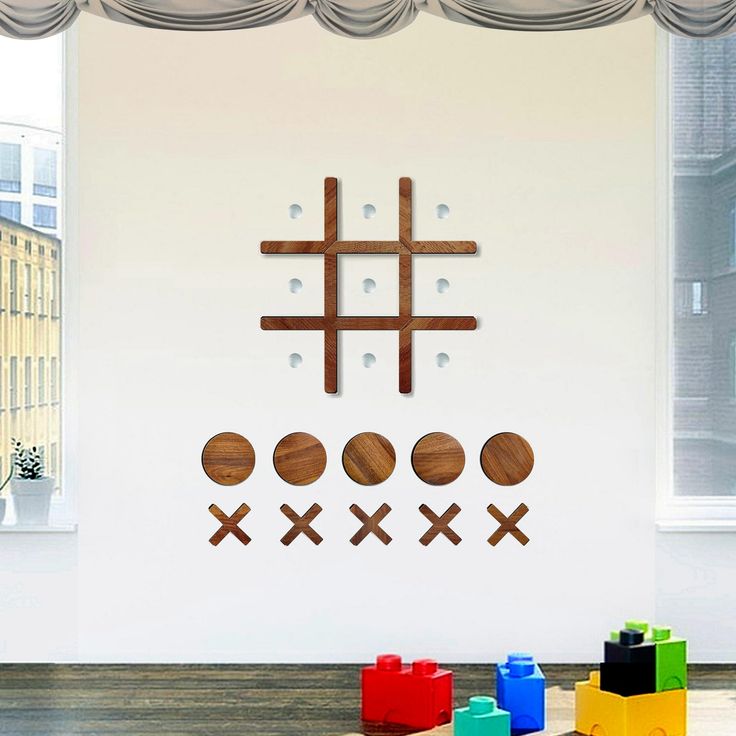 the wall is decorated with wooden crosses and balls