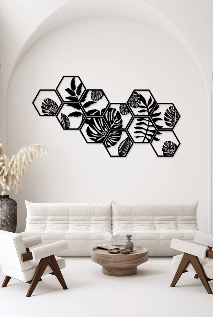 a modern living room with white furniture and wall art