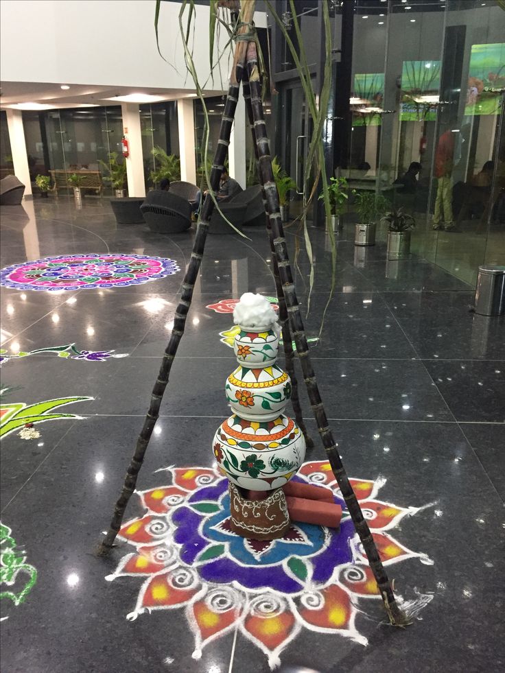 an artistic decoration is displayed on the floor in front of a lobby area with lights and plants