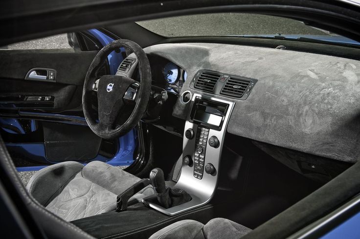 the interior of a sports car is shown in black and blue tones, with leather trims