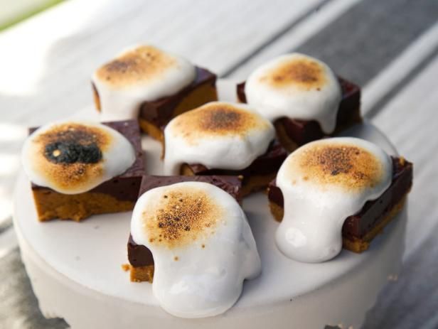 a white plate topped with brownies covered in marshmallows