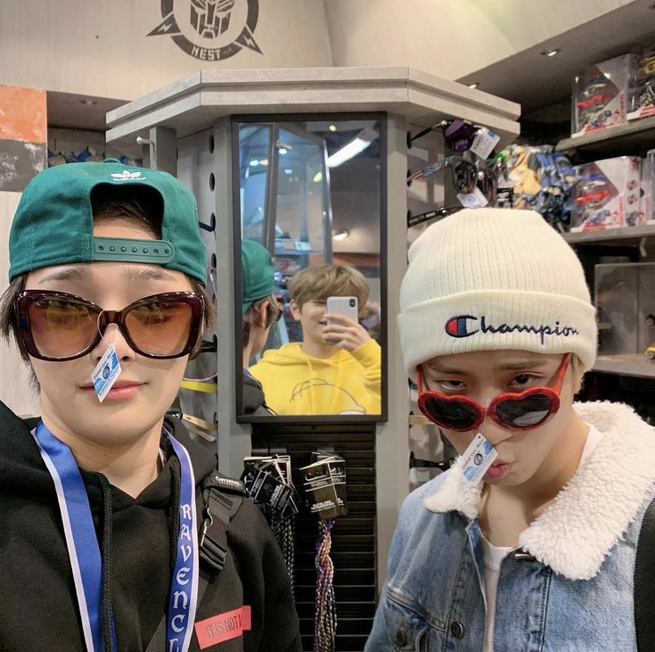 two mannequins wearing hats and sunglasses in a store