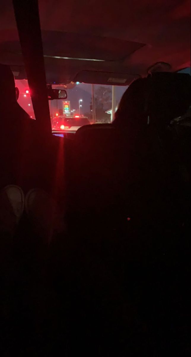 the back seat of a car at night time