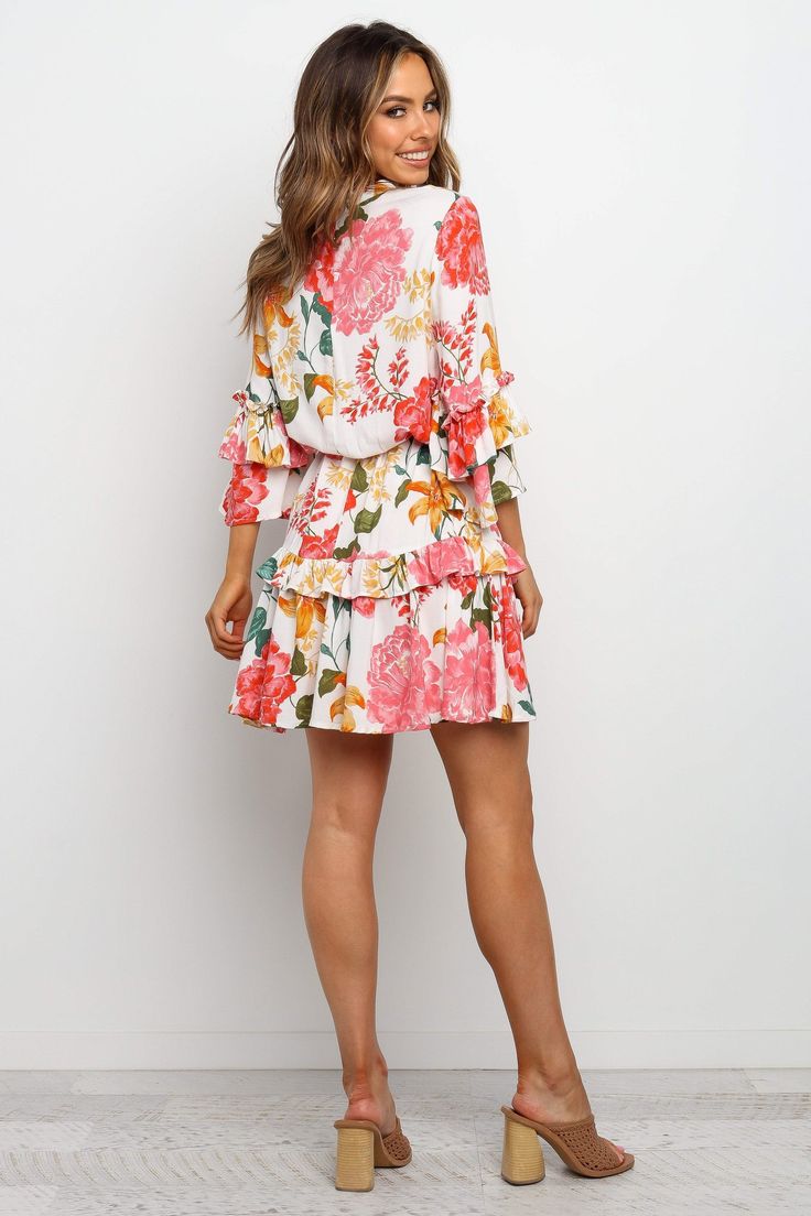 DETAILS
This gorgeous floral dress is perfect for any occasion! It features a round neckline, mid length sleeves with ruffles, and a detachable waist tie. The above the knee hem is finished off with a ruffle detail and invisible back zip - all in our signature fun and feminine style!

above the knee length
mid length sleeves with ruffles
round neckline
detachable waist tie
ruffle hem
invisible back zip
floral print
unlined

material - 100% rayon









SIZING

model is 5' 6" and wears a Size S
model stats: bust - 30", waist - 22.5", hips - 36"













GARMENT CARE

cold hand wash only Petal And Pup, Mid Length Sleeves, Party Dress Long Sleeve, Puff Sleeve Dresses, Party Dress Long, Boho Maxi Dress, Printed Mini Dress, Two Piece Dress, Peta