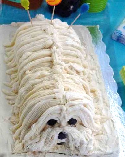 a cake shaped like a dog with toothpicks in it