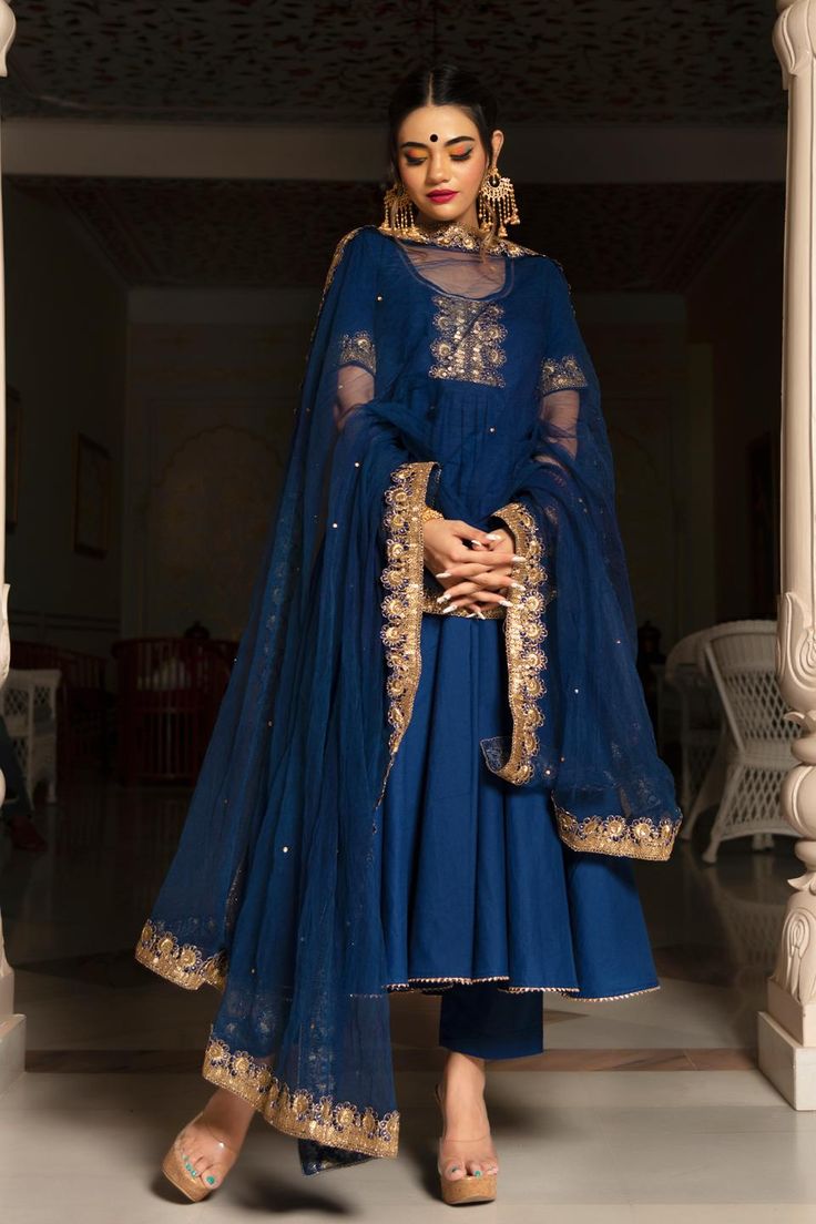 One of our timeless classics, hand-stitched exclusively for your bespoke taste. Channel your desi diva vibes and experience luxury in our all-time favorite festive collection comprising a blue Cotton anarkali with Cotton Pants and soft net Dupatta. Crafted in premium quality Cotton fabric, the blue cotton anarkali comes lace work over neck, sleeves and bottom of anarkali as well as dupatta. PRODUCT DESCRIPTION: Kurta & Pant: Cotton Dupatta: Soft Net Color: Blue No. Of Components : Set of 3 Embro Pomcha Jaipur, Cotton Anarkali Suits, Suit Indian, Blue Anarkali, Blue Dupatta, Cotton Anarkali, Traditional Attires, Embroidered Crop Tops, Anarkali Kurta