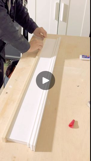 a man is working on an unfinished piece of wood