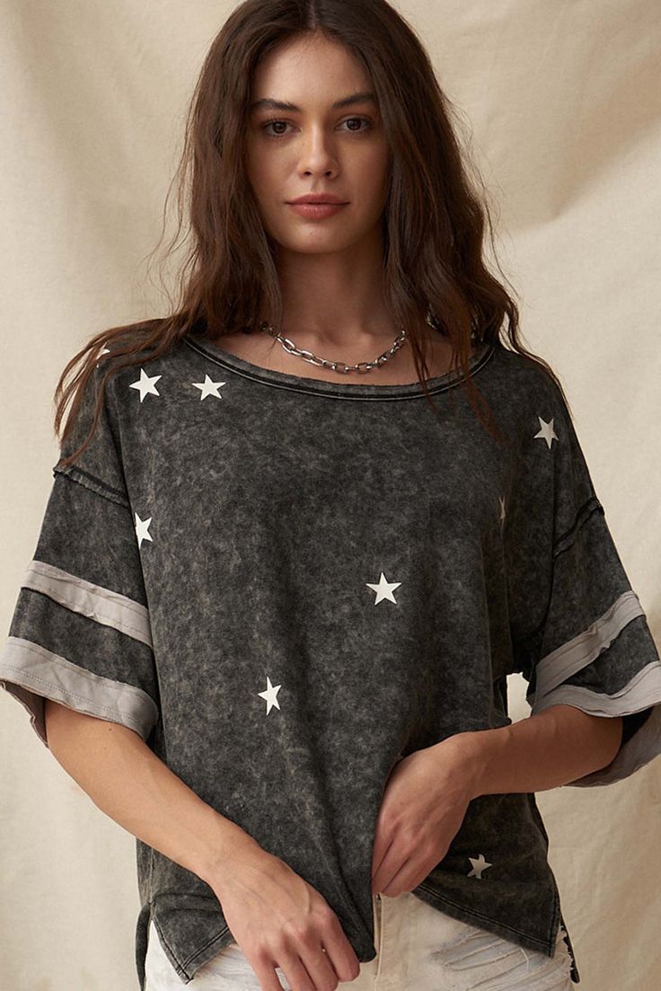 Mineral washed graphic tee. White stars graphic print. Wide short sleeves. Varsity stripe applique. Raw-edge detailing. Drop shoulder. Side split hem. Round neckline. Loose fit. Solid back. 100% Rayon. Imported. Designed in LA. Model wears size S. Stars Graphic, Vintage Varsity, Star Vintage, White Stars, Lucky Star, Side Split, Split Hem, Raw Edge, Drop Shoulder