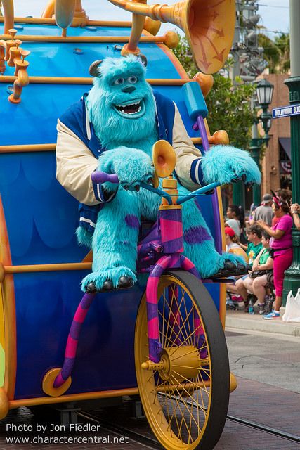 monsters riding in the back of a blue and yellow carriage